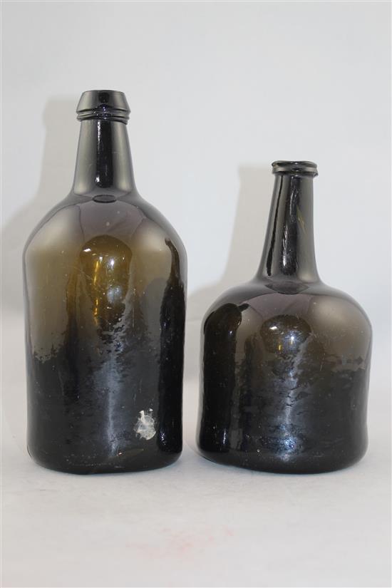 Two English dark green glass wine bottles, 18th century, 25cm.